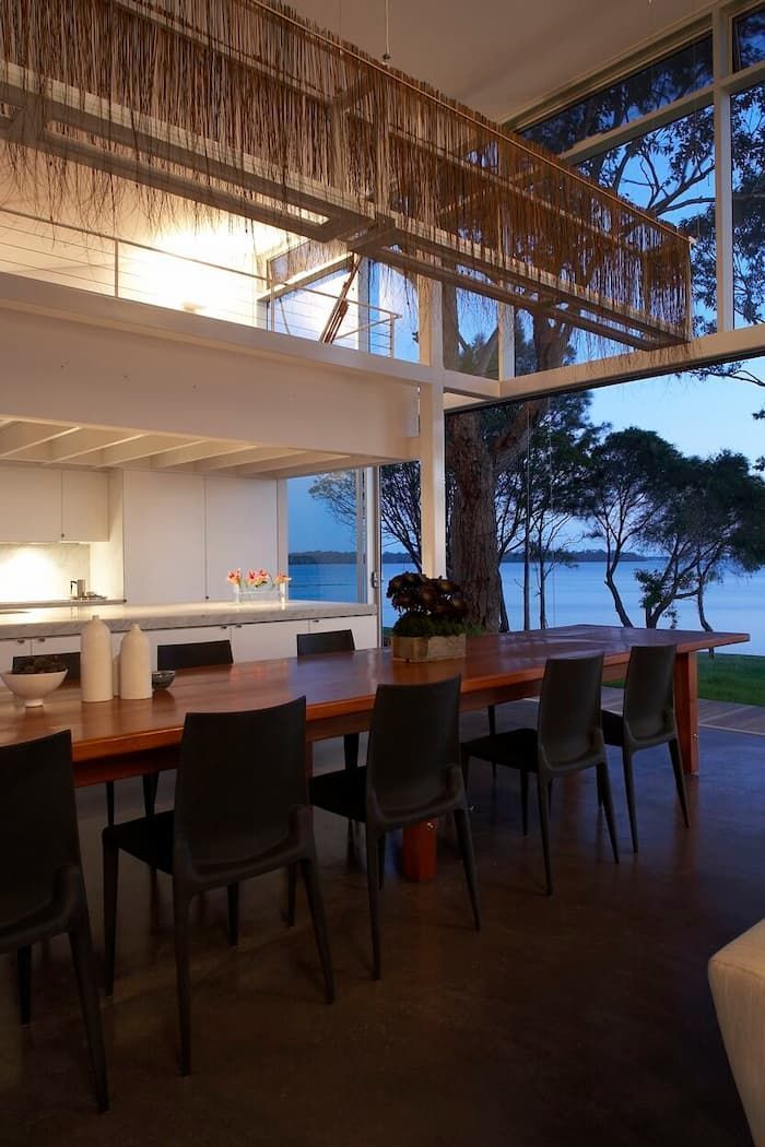 A Dining Room Table And Chairs In A House With A View Of The Ocean — South Coast Glass In South Nowra, NSW
