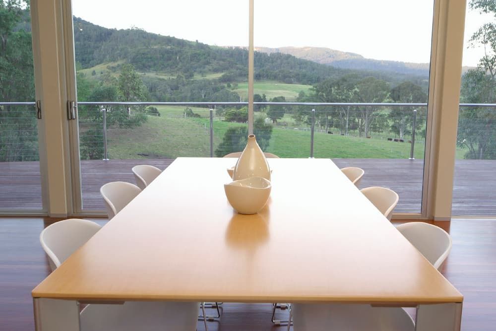 A Dining Room Table With A View Of A Field And Mountains — South Coast Glass In South Nowra, NSW
