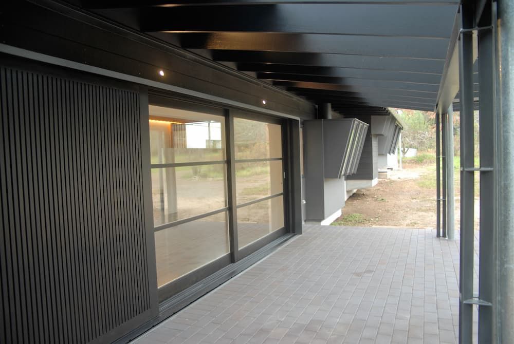 A Patio With Sliding Glass Doors Leading To A House — South Coast Glass In South Nowra, NSW