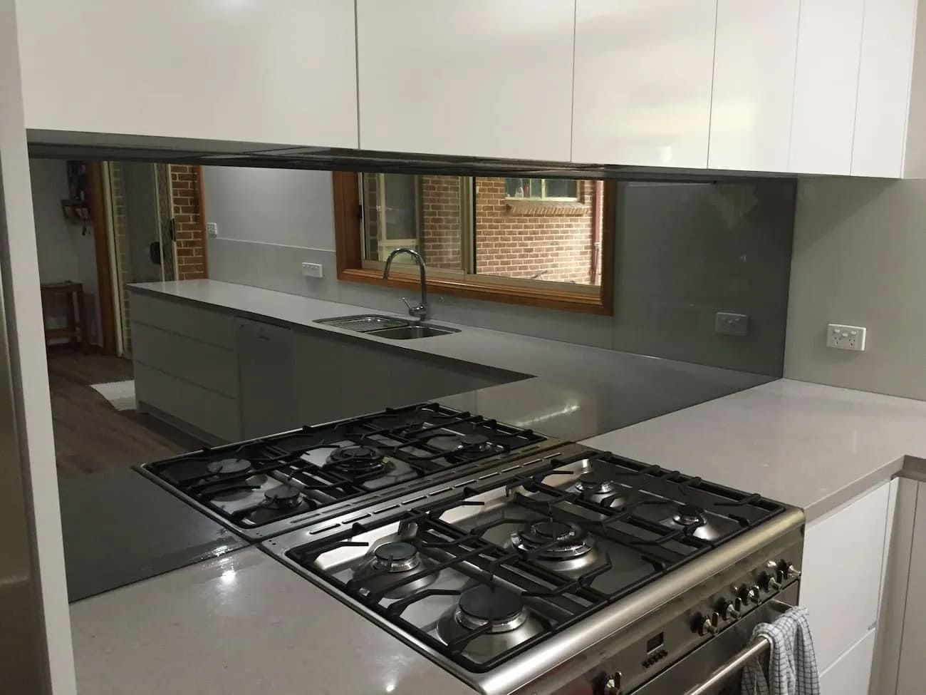 A Kitchen With A Stove Top Oven And A Mirrored Wall — South Coast Glass In South Nowra, NSW