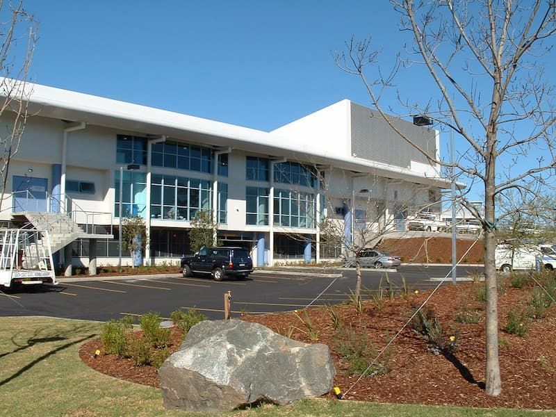 A Large Building With Cars Parked In Front Of It — South Coast Glass In South Nowra, NSW