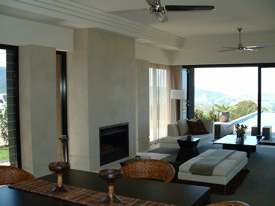 A Living Room With A Fireplace And A Ceiling Fan — South Coast Glass In South Nowra, NSW