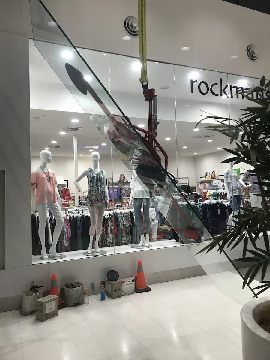 A Glass Staircase Is Being Installed In A Store — South Coast Glass In South Nowra, NSW
