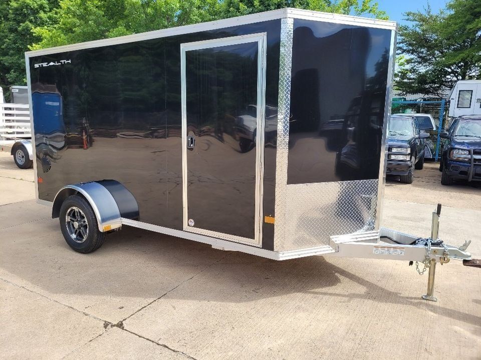 Black enclosed cargo trailer with silver trim and diamond plate front. | Gainesville Garage & Trailer Sales