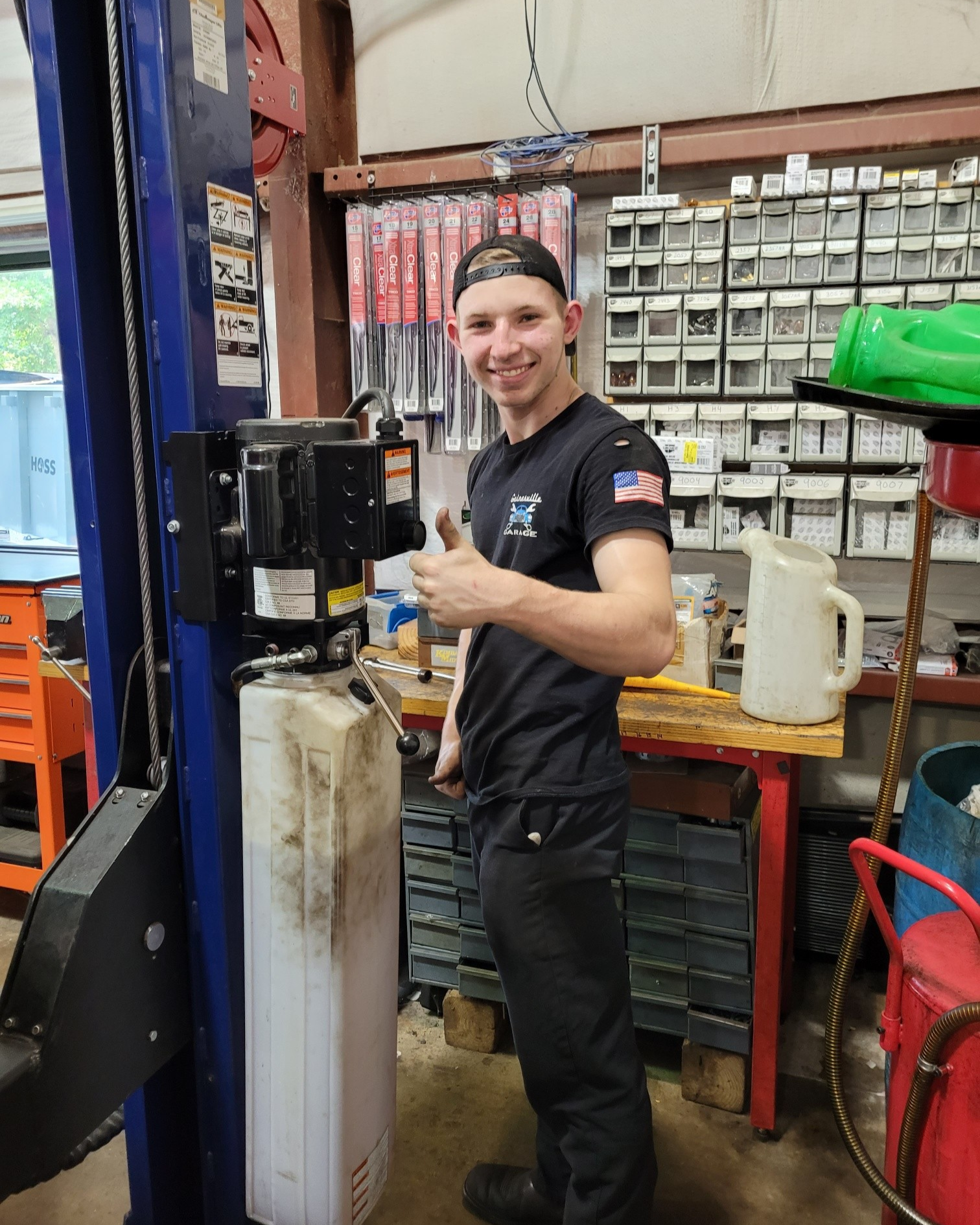 Mechanic giving thumbs up inside the auto shop | Gainesville Garage & Trailer Sales