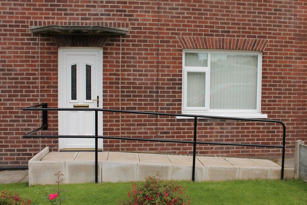 A Brick House With a White Door and a Black Railing — All Clean Pressure Cleaning in Toronto, NSW