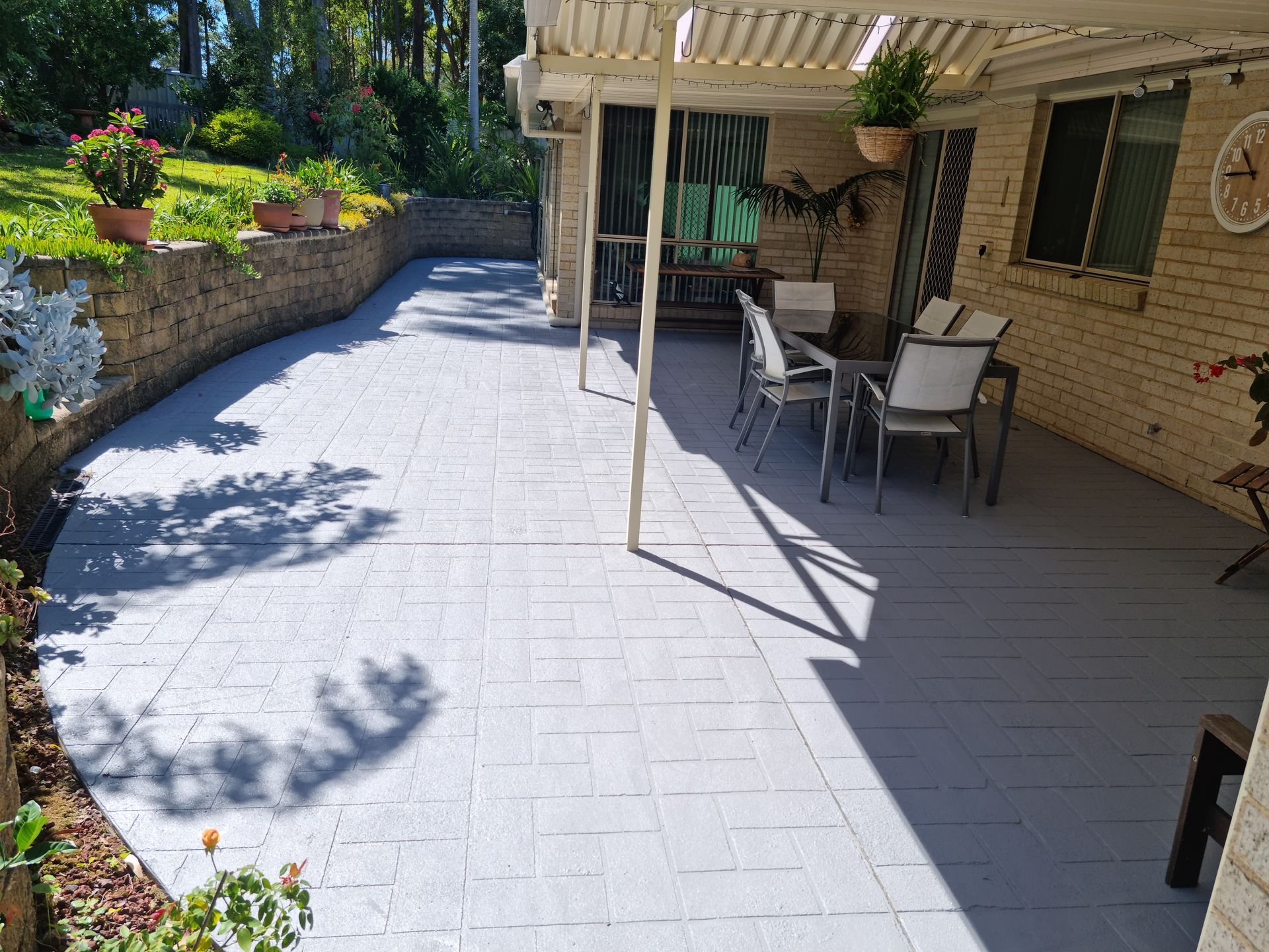 A Patio With a Table and Chairs Under a Pergola — All Clean Pressure Cleaning in Valentine, NSW
