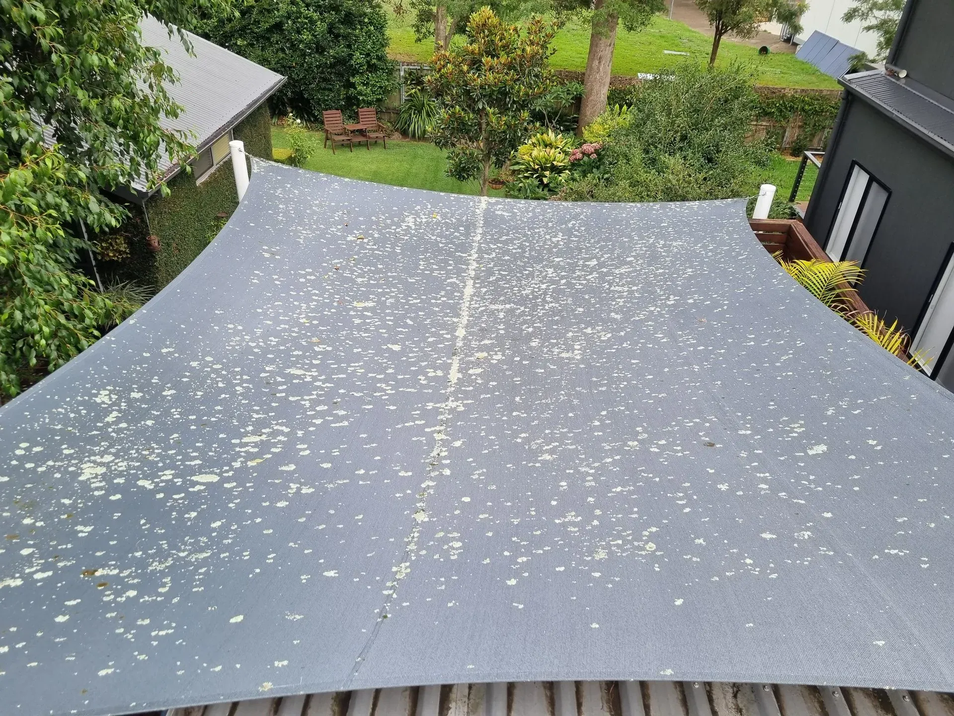 A Large Gray Umbrella is Sitting on Top of a Wooden Deck — All Clean Pressure Cleaning in Valentine, NSW