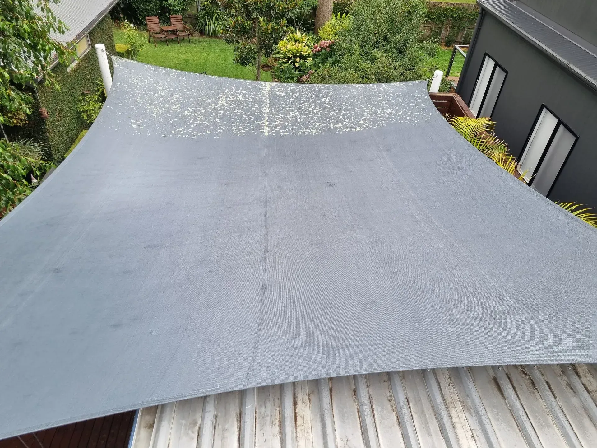 A Large Gray Tarp is Sitting on Top of a Wooden Roof — All Clean Pressure Cleaning in Valentine, NSW
