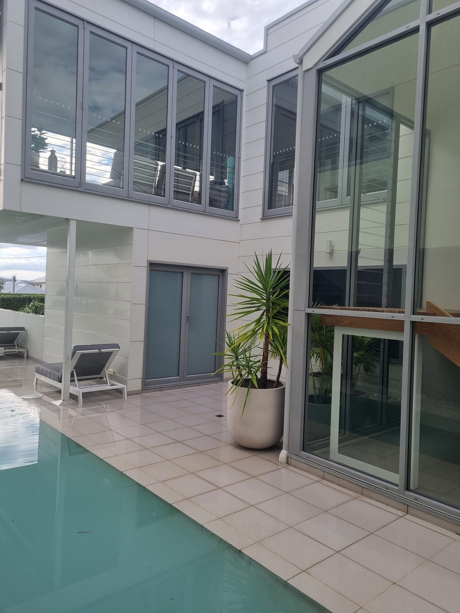 A Large Building With a Swimming Pool in Front of It — All Clean Pressure Cleaning in Valentine, NSW