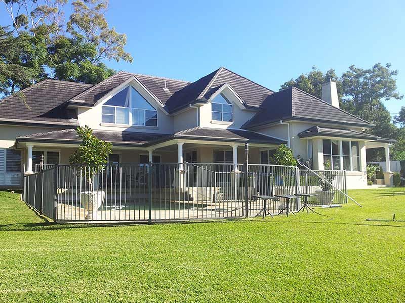 A Large House With a Fence in Front of It — All Clean Pressure Cleaning in Valentine, NSW