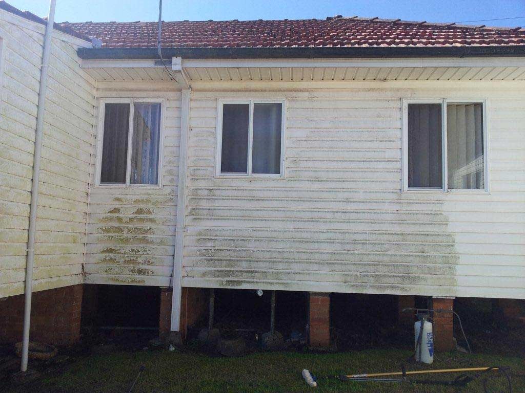 The Back of a White House With a Red Tile Roof — All Clean Pressure Cleaning in Valentine, NSW