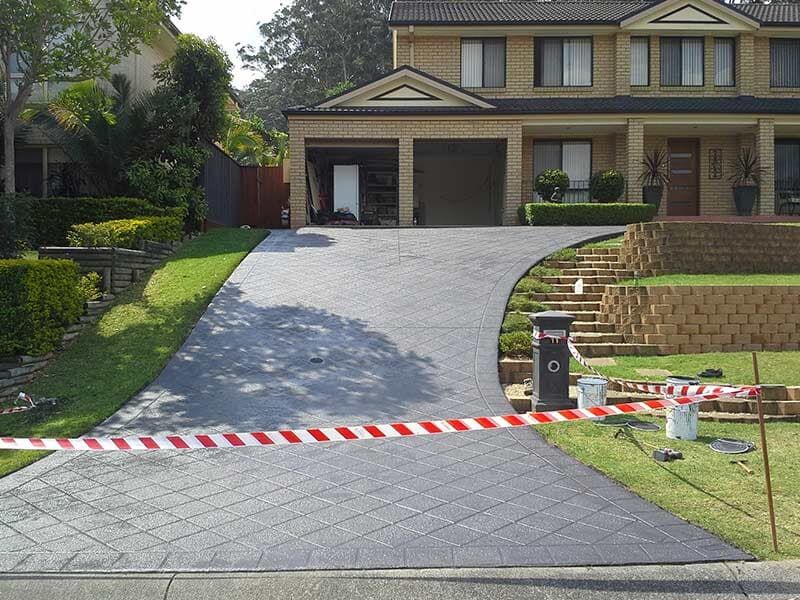 A Large House With a Driveway That is Being Painted — All Clean Pressure Cleaning in Valentine, NSW