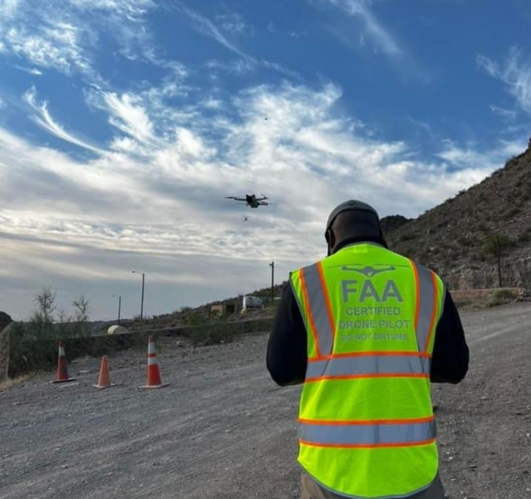 An image portraying an individual holding an FAA (Federal Aviation Administration) drone pilot license or certificate.