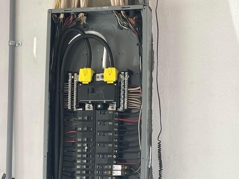 Open residential electrical panel with breakers and whole-home surge protector