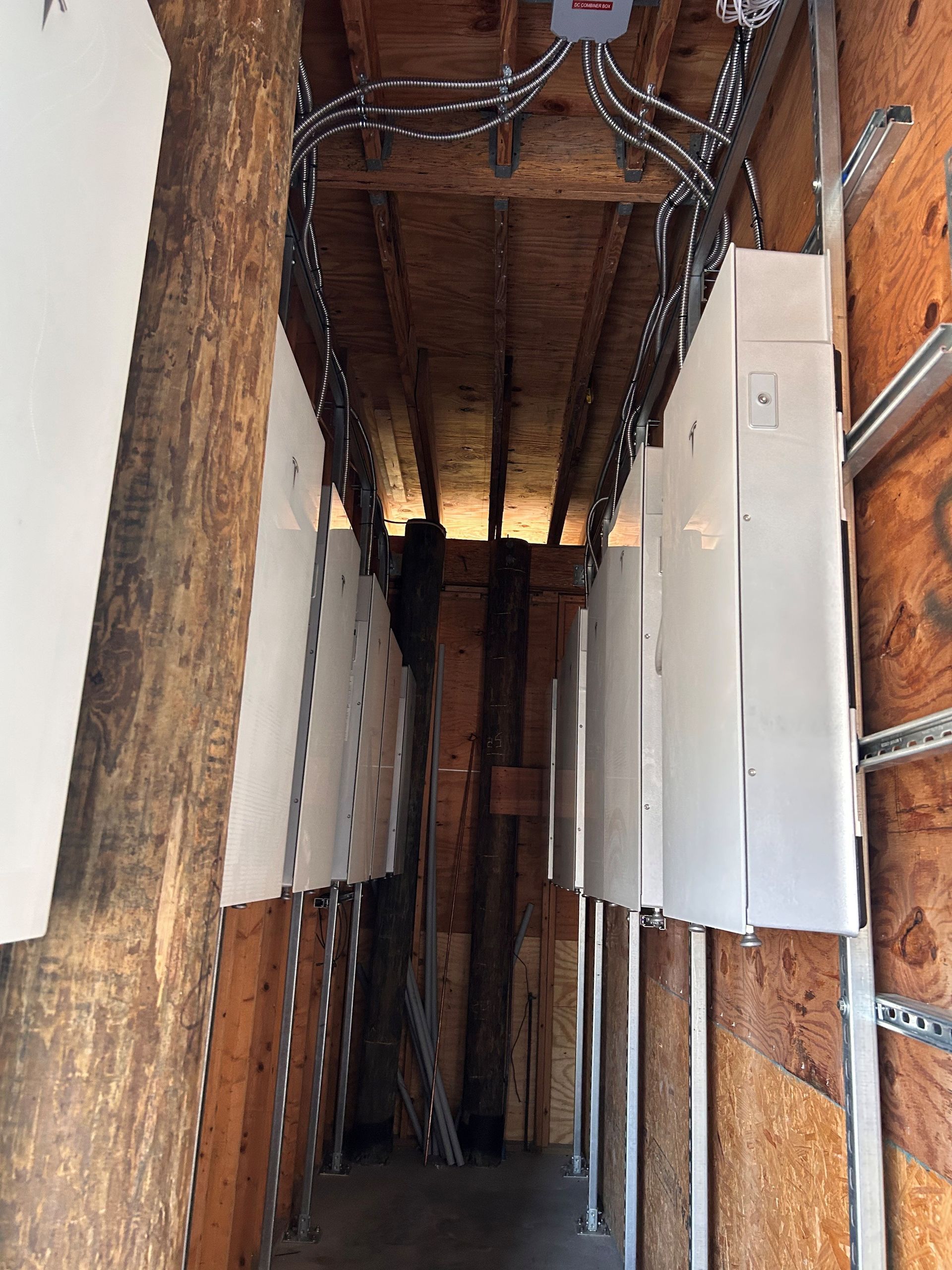 Bundled cables overhead cleanly running through the new renovation job site to their electrical panels
