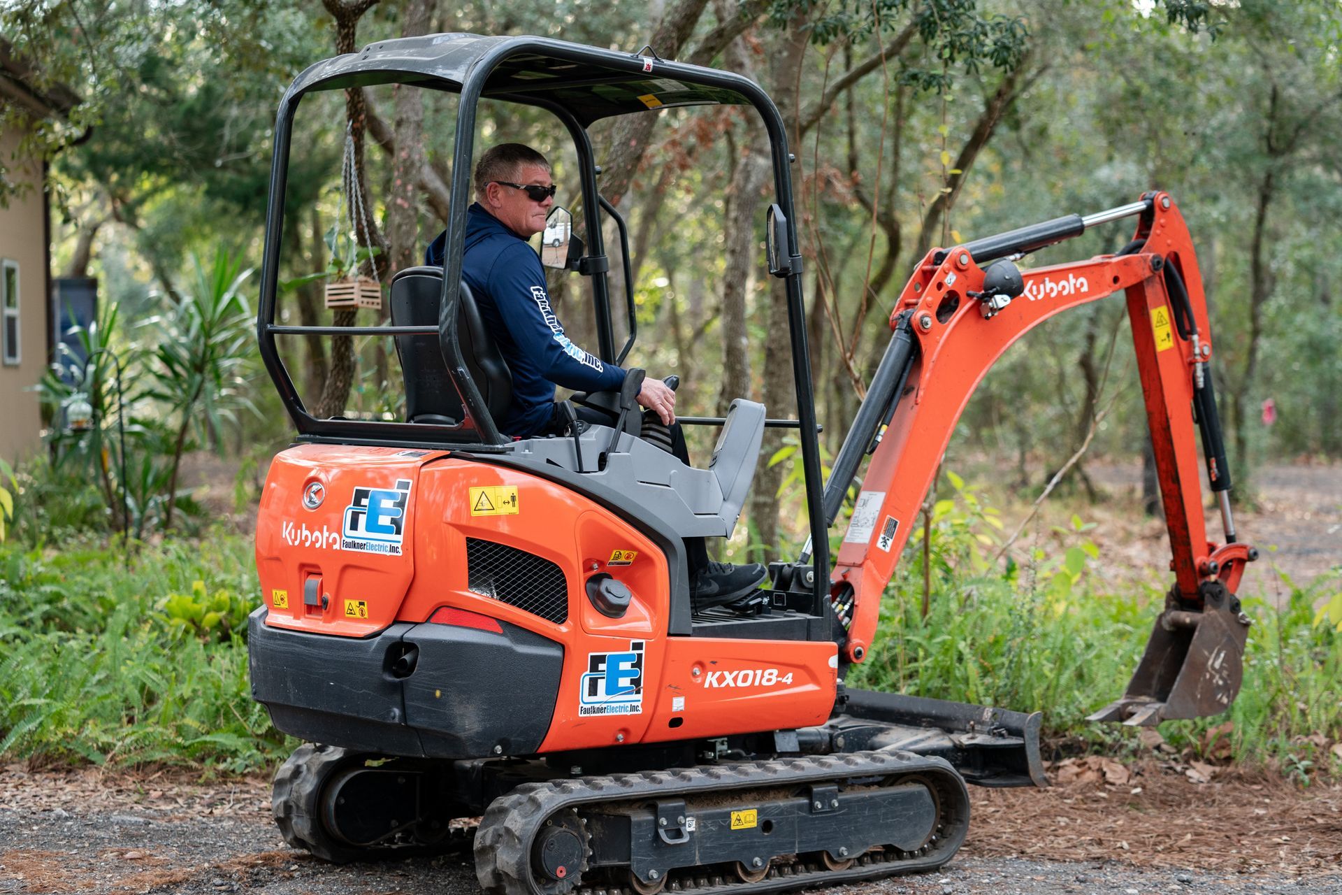 Faulkner Electric Employee on our mini excavator for a job requiring large trench dug for wiring.