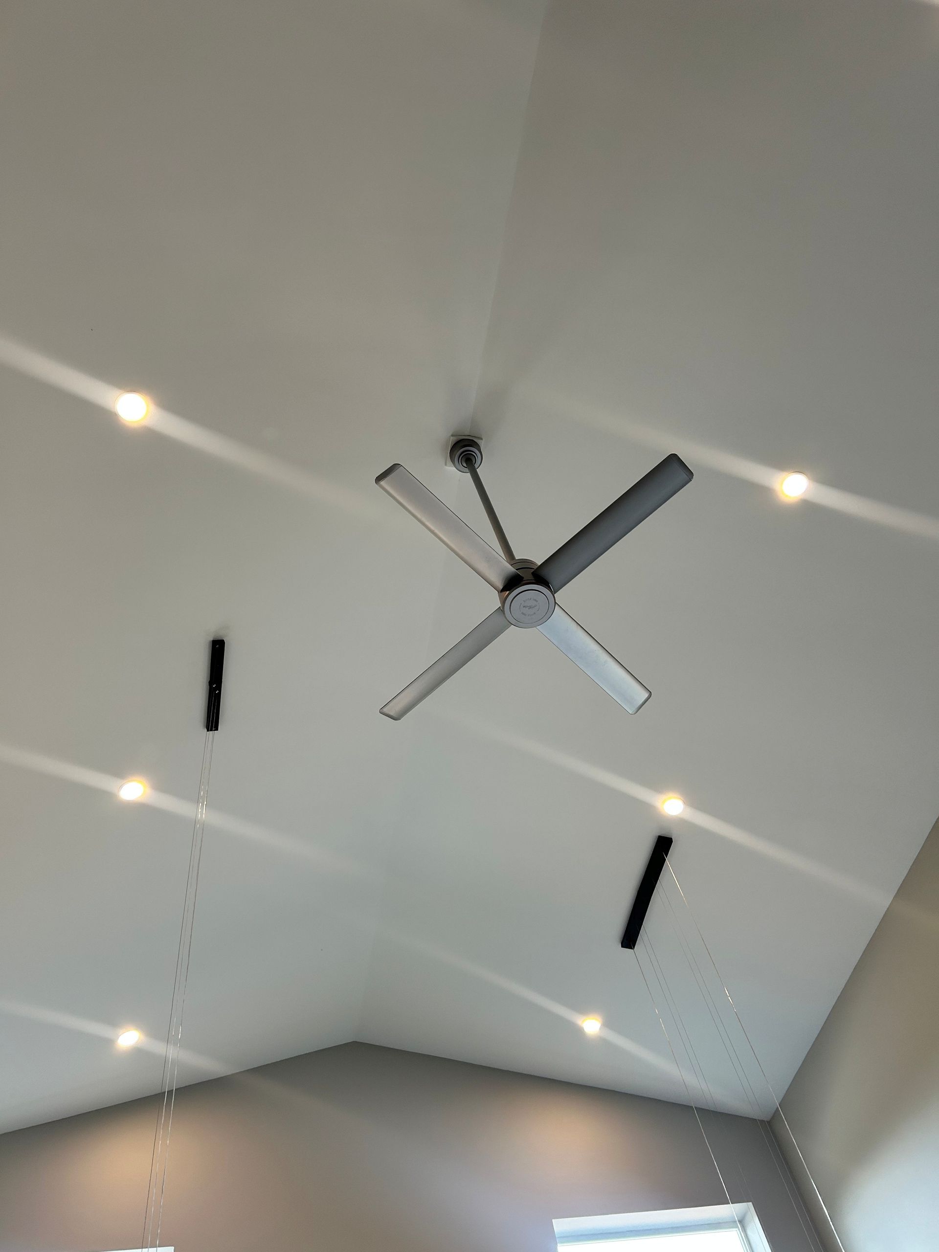High-ceiling recess lights installed by Faulkner Electric over a ceiling fan.