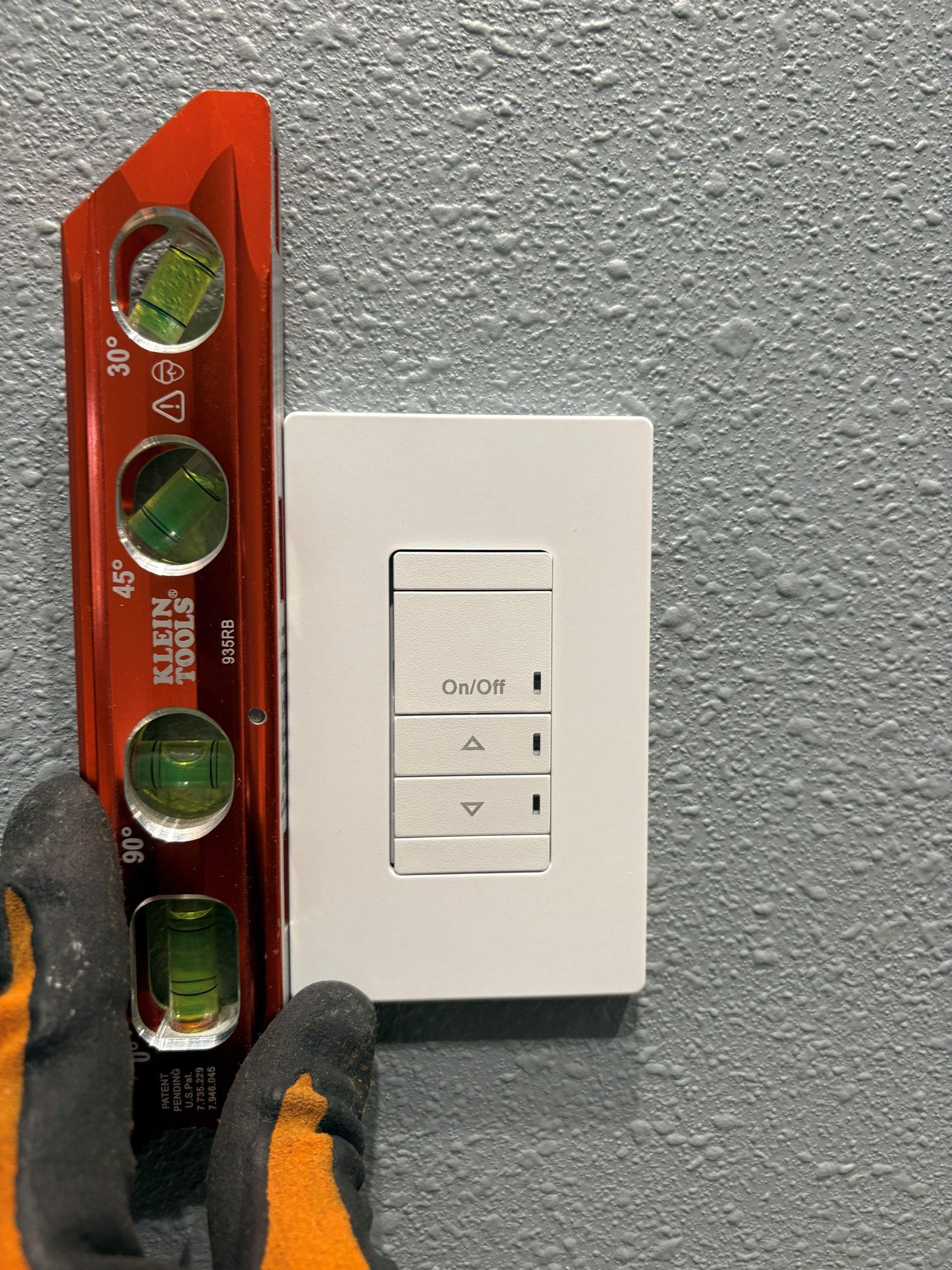 Level being used to properly align light switches on a new residential home in West Central Florida