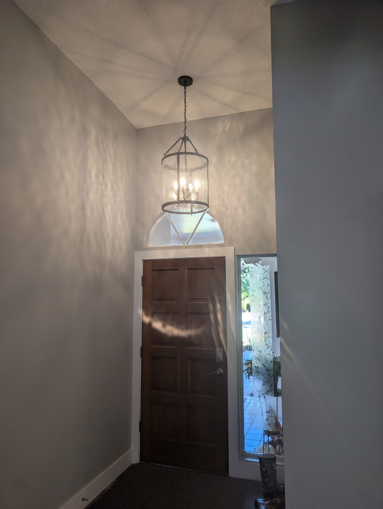 Chandelier installation by Faulkner Electric - Illuminating the home entrance