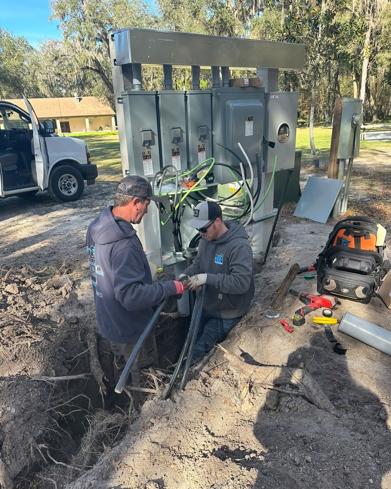 Faulkner Electrician working on large electrical panel outside