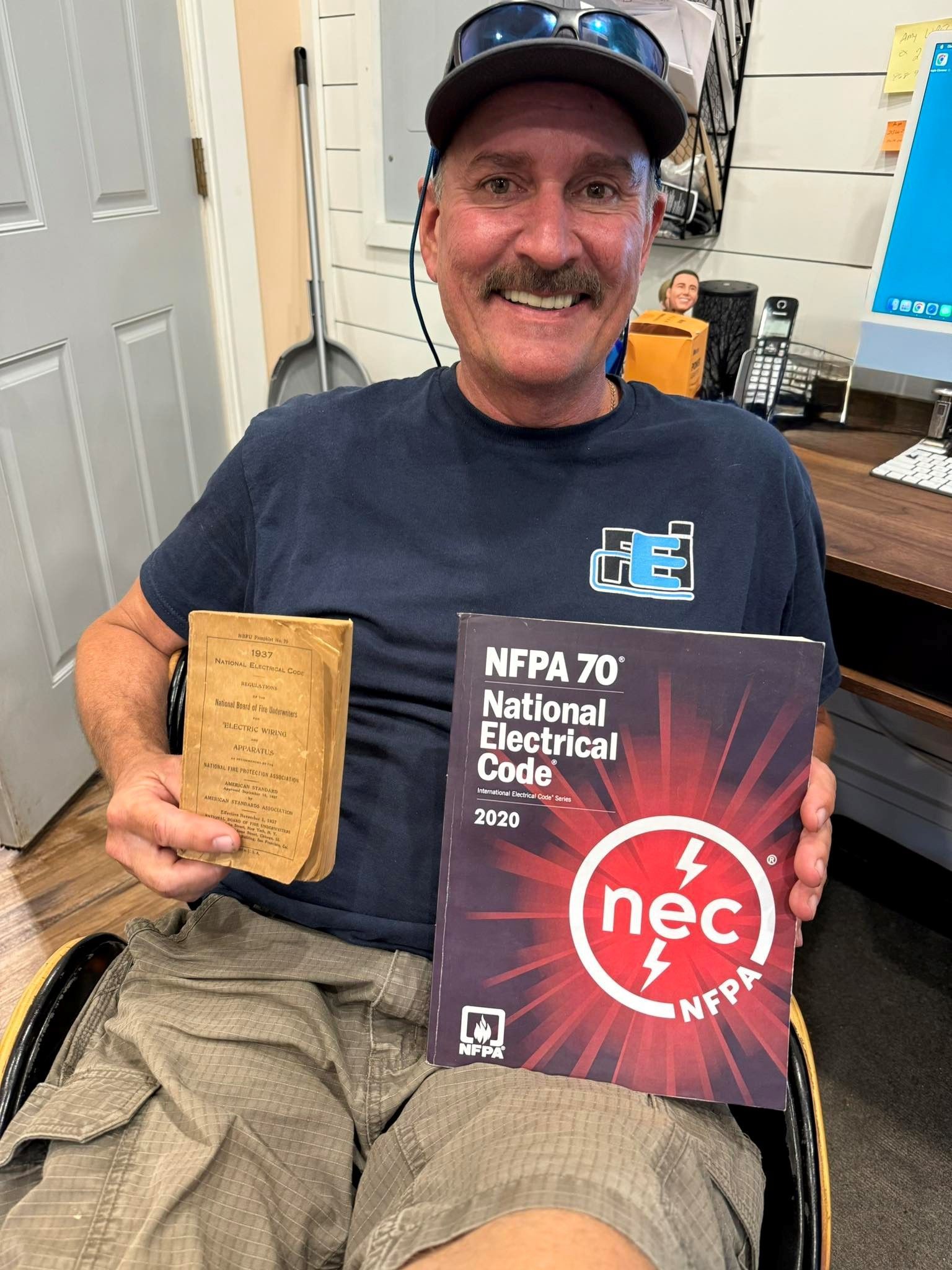 Faulkner Electric employee smiling for his photo from inside our main Spring Hill, Florida office