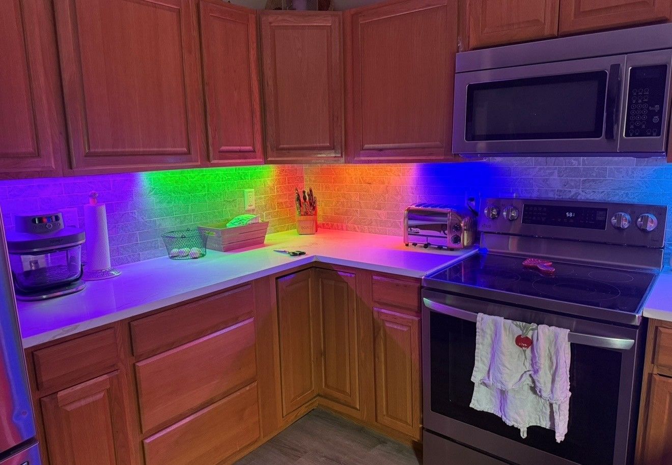Red, green, blue (RGB) lights installed in residential kitchen - illuminating the countertops