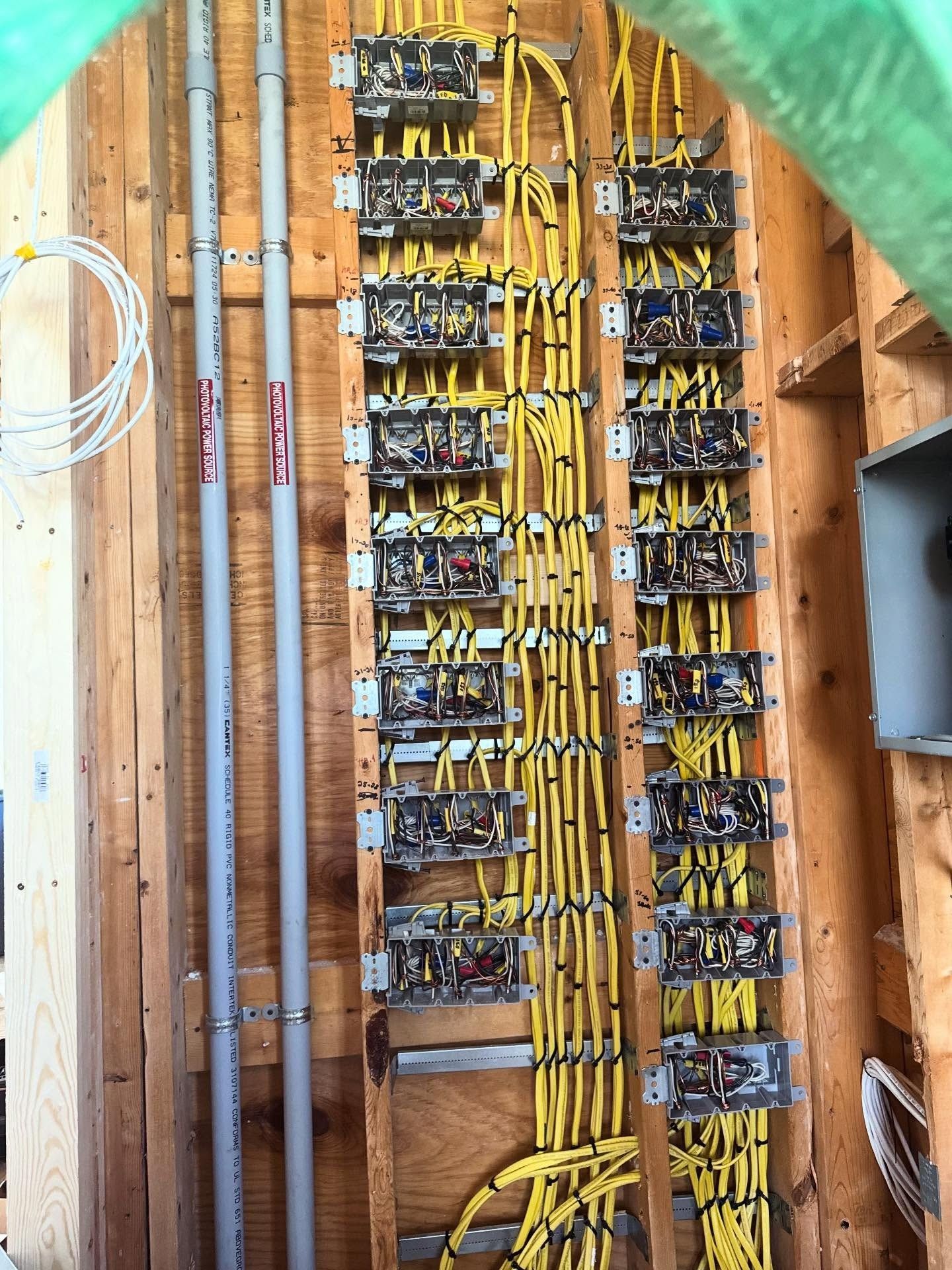 Clean, tight, yellow electric cables in a new build done by Faulkner Electric