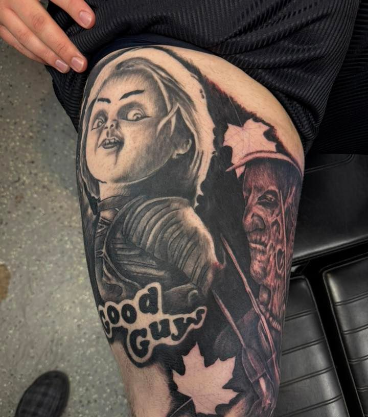 Tattooed upper arm with black-and-gray portrait, hooded figure, and maple leaf design