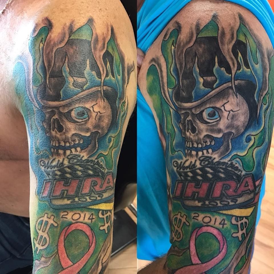 Two colorful calf tattoos: skull in a crown with “IHRA” and “2014” on blue-clad legs.