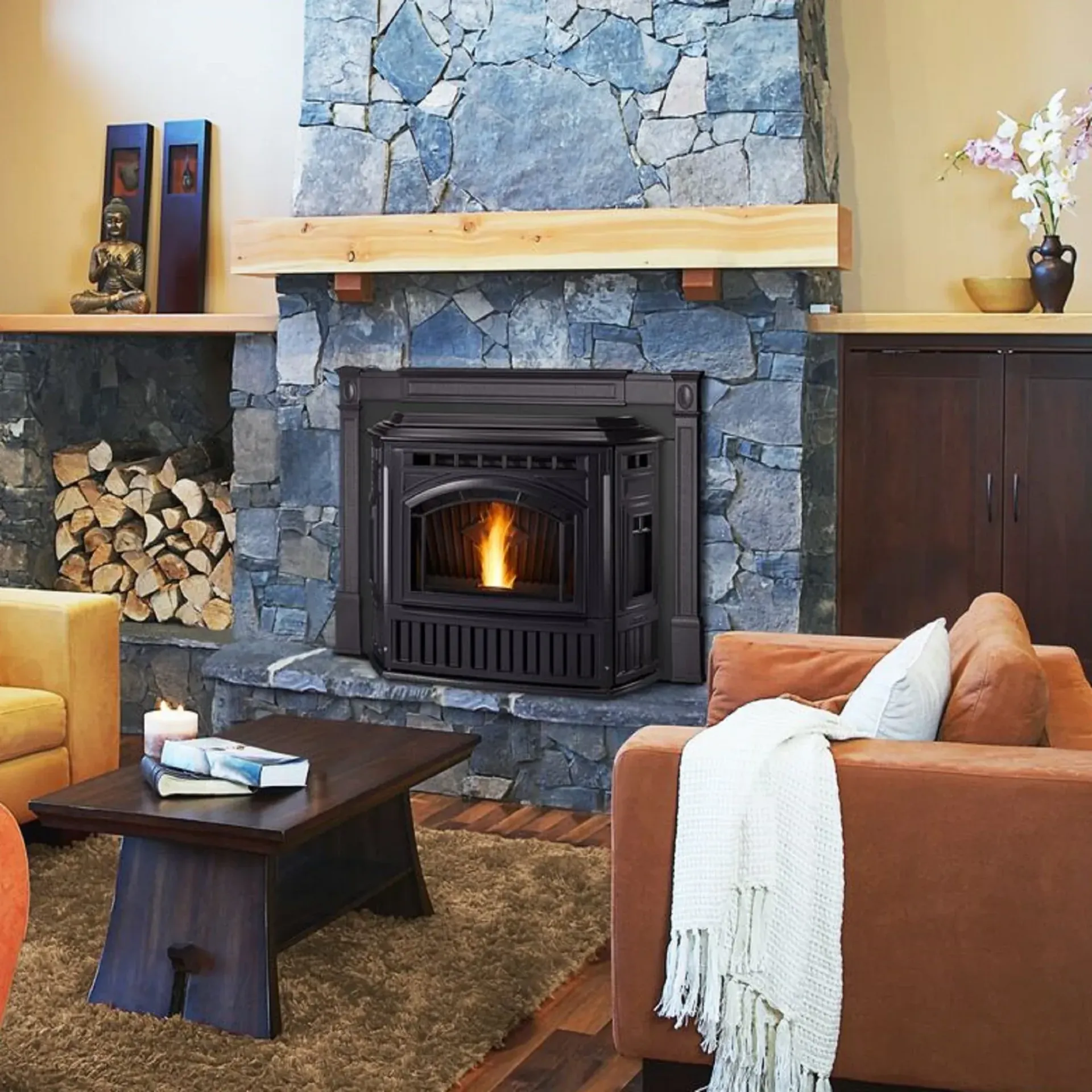 Rustic fireplace showroom with multiple wood stoves, stone walls, and warm ambient lighting