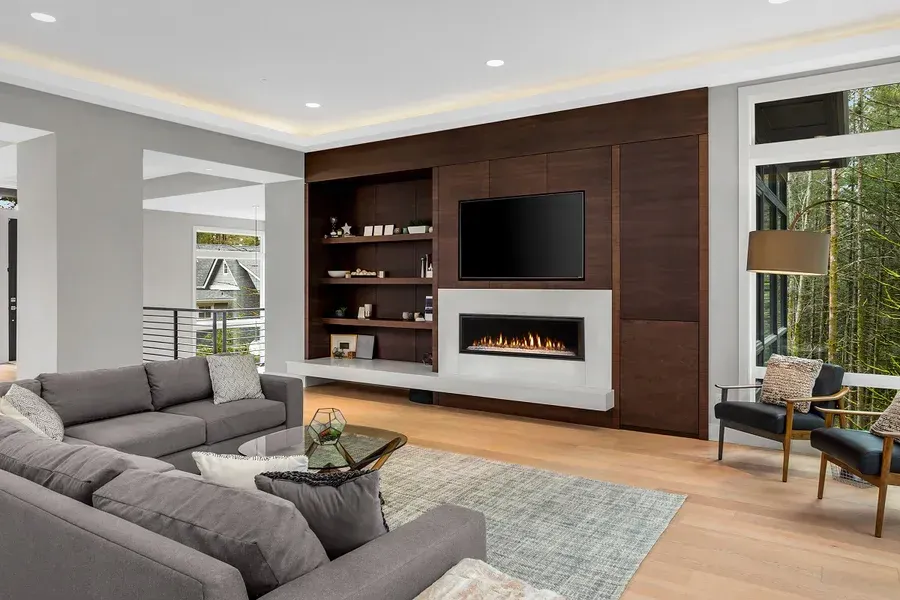 Rustic lodge interior with stone fireplaces, wood-paneled walls, and warm lighting