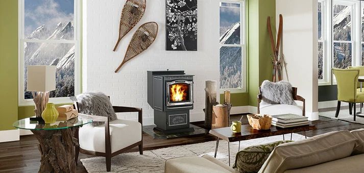 Modern living room with a lit fireplace, cream sofas, and bright pink and patterned pillows