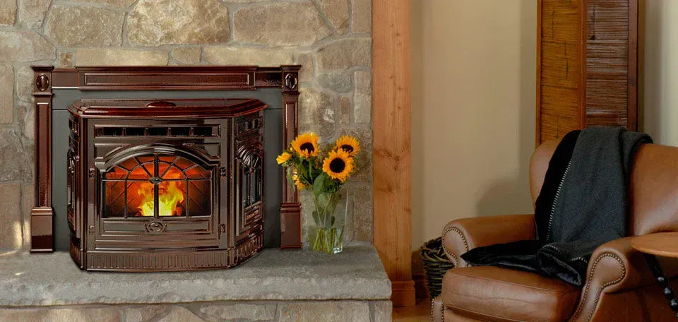 Cozy kitchen and living area with wood stove, red chair, wall clock, and basket of firewood