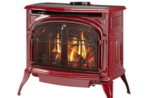 Red cast-iron fireplace stove with a glass front and visible flames burning inside.
