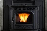 Black cast-iron fireplace with bright flames burning inside.