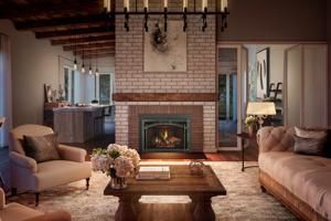 Cozy living room with brick fireplace, tan sofa, armchairs, and wooden coffee table