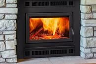 Lit fireplace with bright orange flames inside a stone hearth