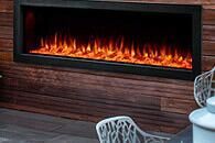 Modern outdoor fireplace with bright flames in a brick wall setting