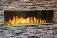 Modern linear fireplace with bright flames set into a stacked stone wall.