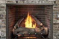 Brick fireplace with a burning log fire and orange flames