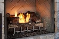 Gas fireplace with bright flames and ceramic logs set in a tiled hearth