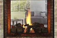 Modern fireplace with a burning fire and gray sofa in the background
