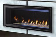 Modern wall-mounted gas fireplace with black frame and visible flames