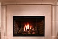 Lit fireplace with flames behind glass in a beige tiled mantel