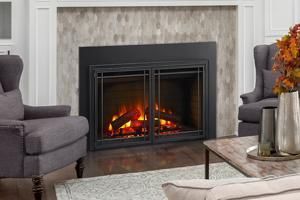 Modern living room with a lit fireplace, gray chairs, and a patterned rug
