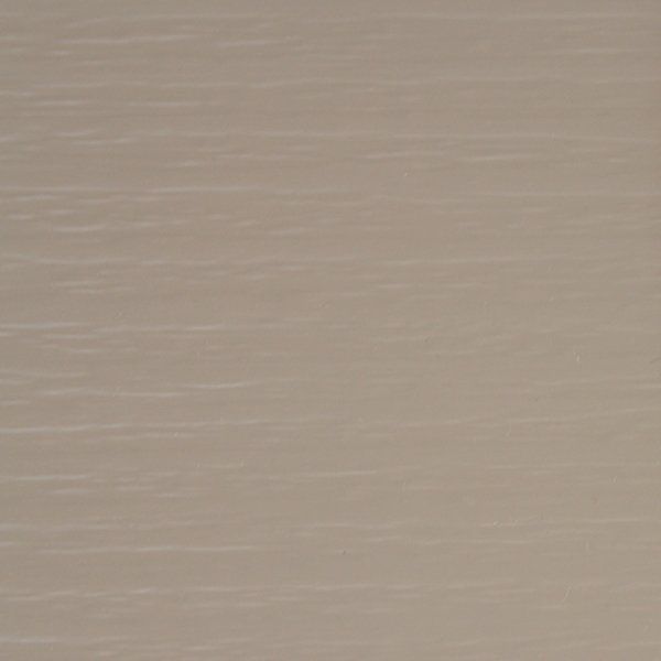 Close-up of a neutral, pale beige surface with subtle horizontal wood grain lines.