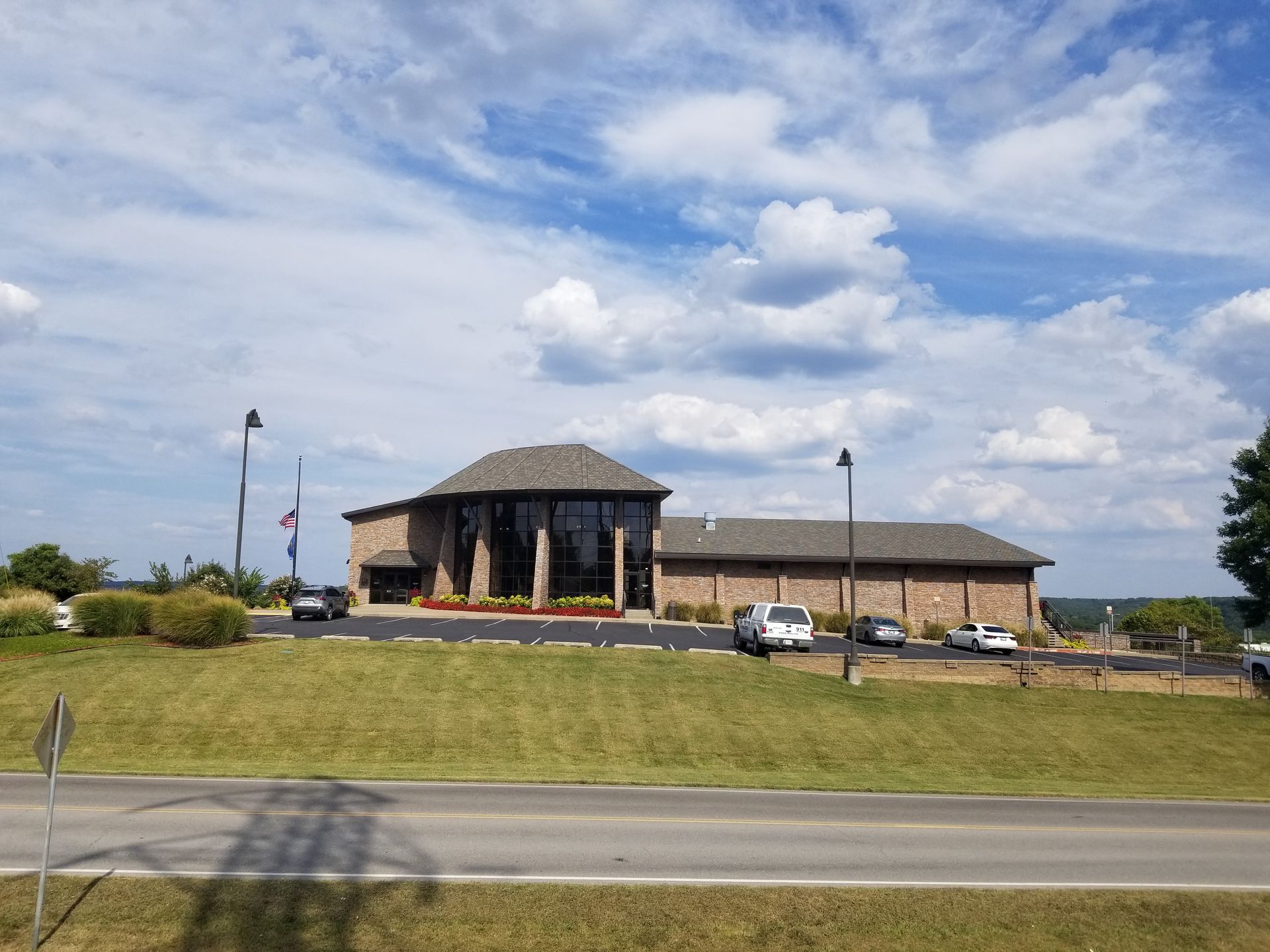 A large building with a lot of cars parked in front of it