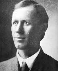 A black and white photo of a man in a suit and tie.