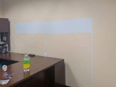 Light blue painted rectangle on a tan wall above a dark brown counter. A clear bottle sits on the counter.